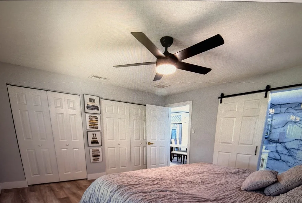 Modern ceiling fan installed by PHM Solutions in a Pinellas bedroom